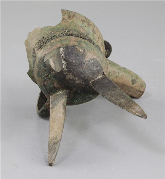 A Chinese archaic bronze tripod ritual wine vessel, Jue, Shang dynasty, 13th-12th century B.C., Anyang, 17cm high, large losses to rim